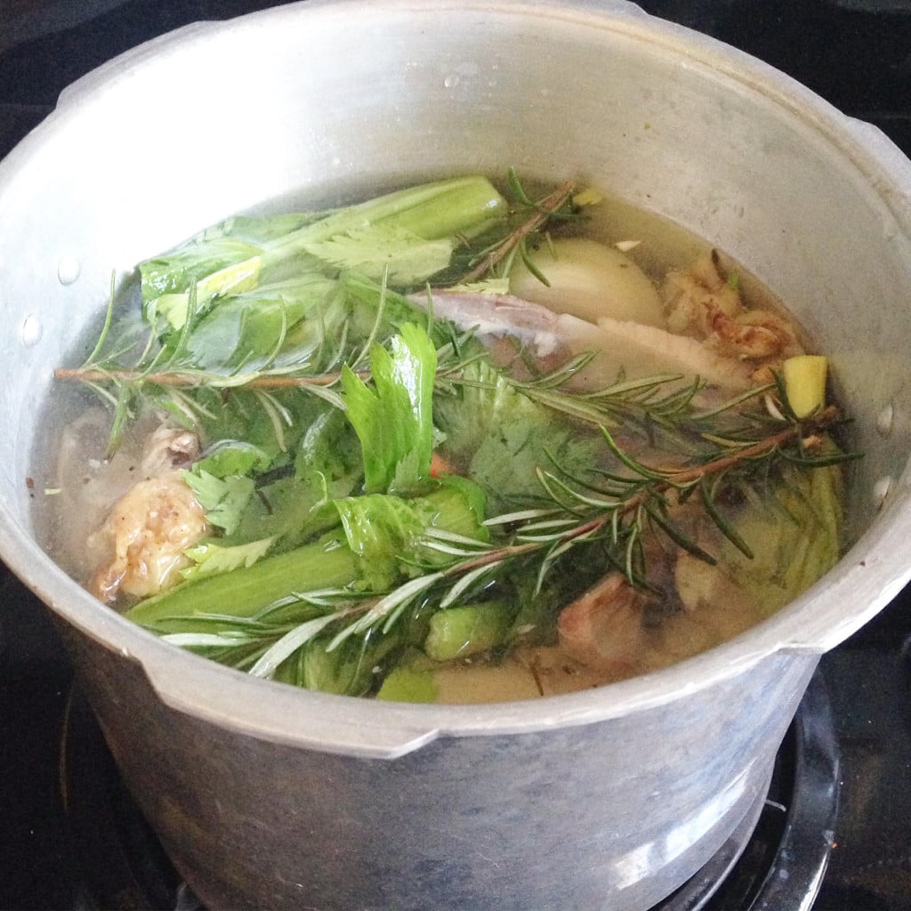 bone broth in a pressure cooker with rosemary