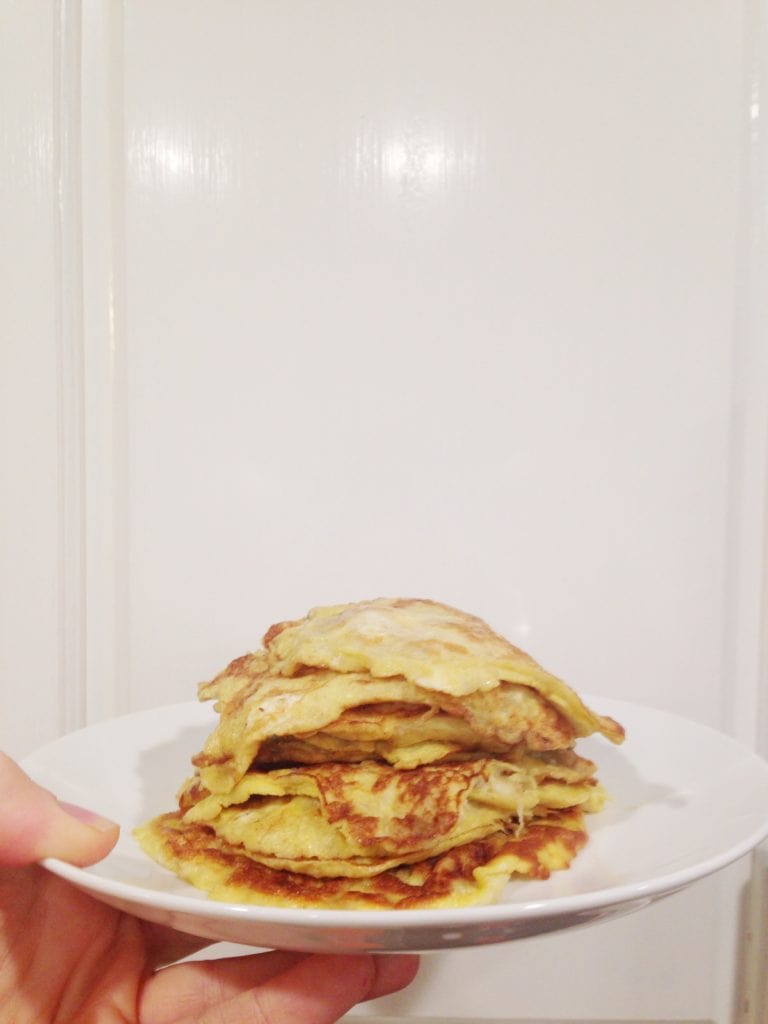 plate of banana egg pancakes on white plate with white background