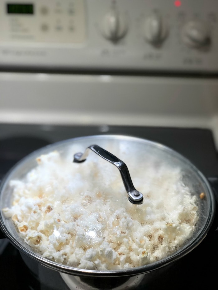 By using my step-by-step instructions you will have perfectly popped coconut oil popcorn made on the stove with minimal (if not zero!) unpopped kernels.  Life goals, people!  Let's get started.