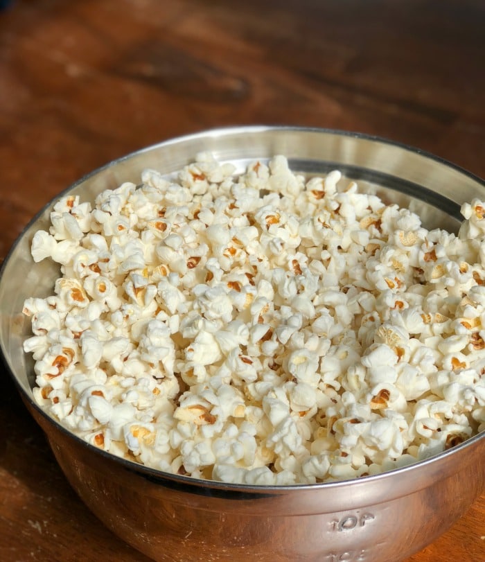 By using my step-by-step instructions you will have perfectly popped coconut oil popcorn made on the stove with minimal (if not zero!) unpopped kernels. Life goals, people! Let's get started.