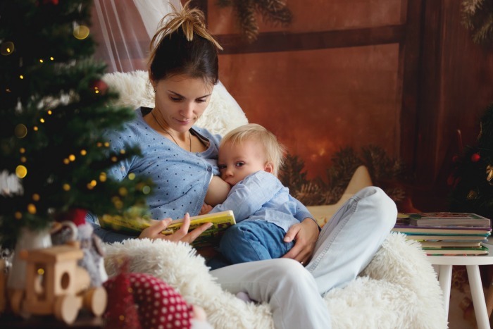 Woman taking a breastfeeding break during the holidays to avoid holiday mastitis.