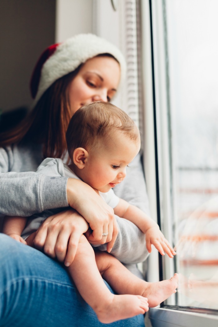 Wherever you're at - mom of a tiny newborn, crawler, or mini-toddler - in this article you'll find practical tips for navigating baby's first Christmas.  #christmas #newborn #postpartumtips #babysfirstchristmas #firstchristmas