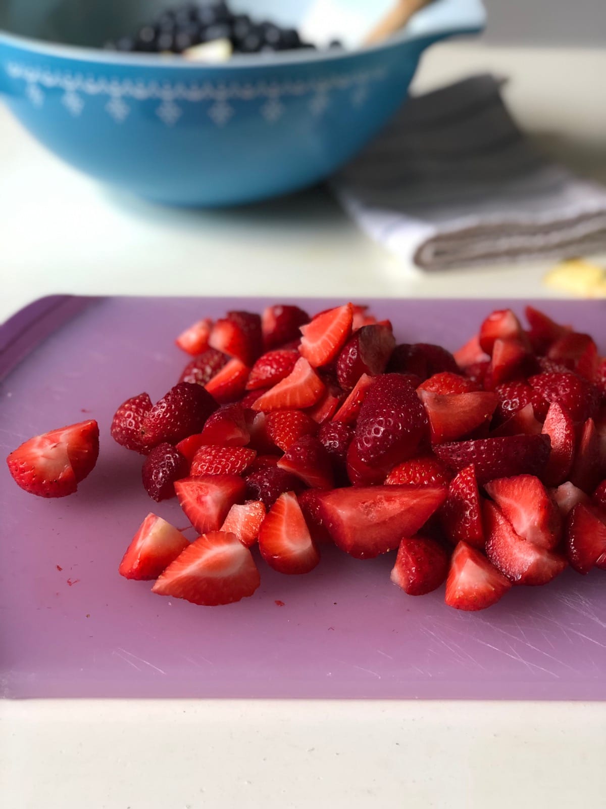 Slice strawberries for Chick-Fil-A Fruit Cup into bite-size pieces.
