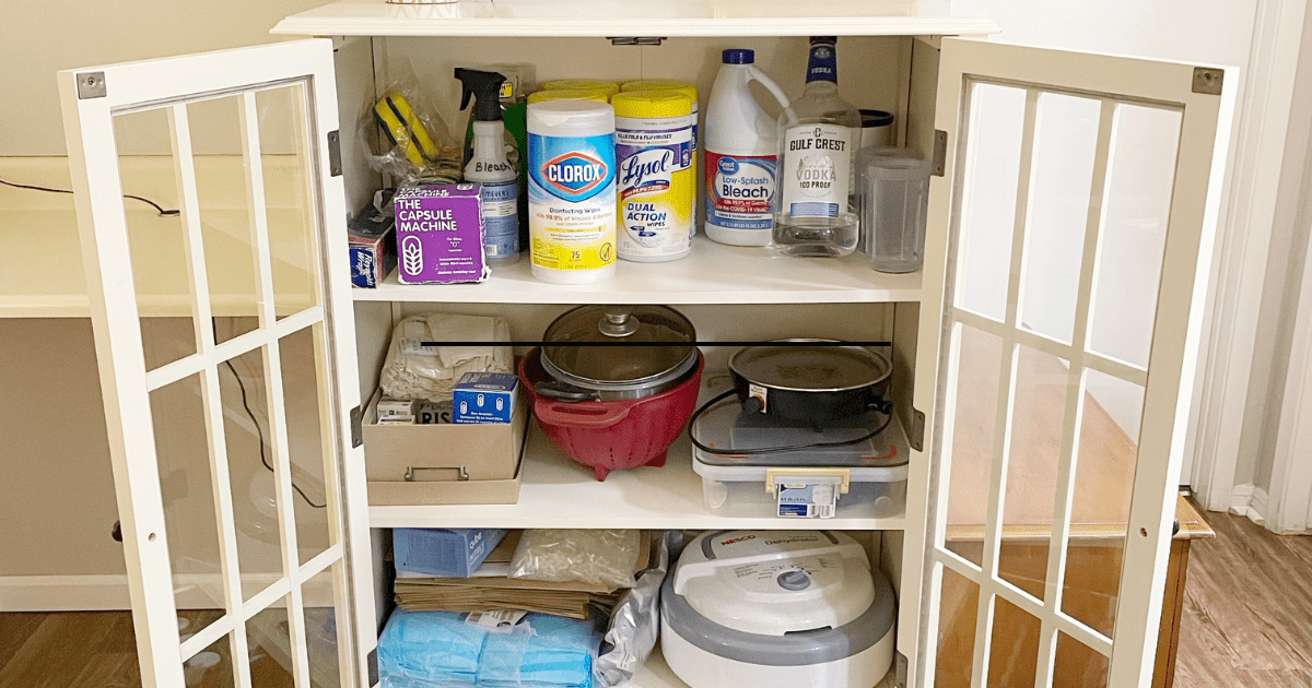 three shelf white cabinet full of placenta encapsulation supplies